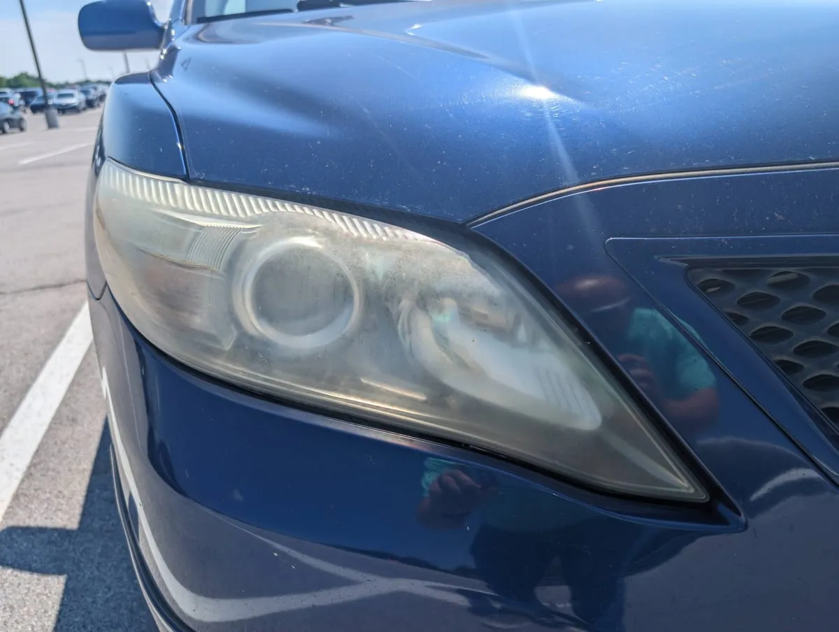 Before headlight restoration — heavily oxidized headlight