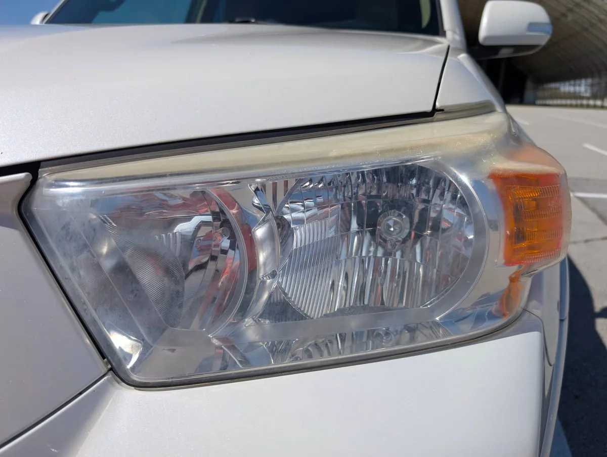 Before headlight restoration — oxidized plastic headlight cover