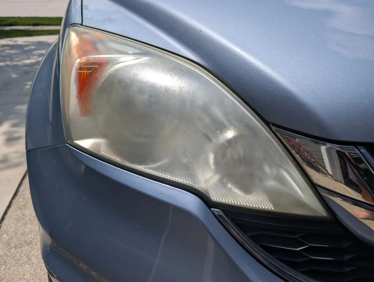 Before headlight restoration — yellowed plastic headlight