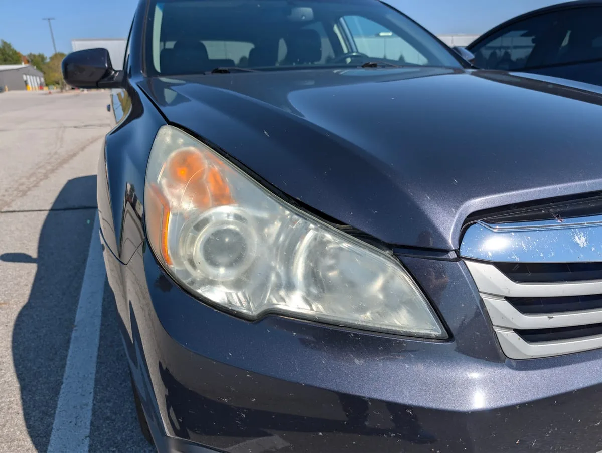 Before headlight restoration — cloudy oxidized headlight cover